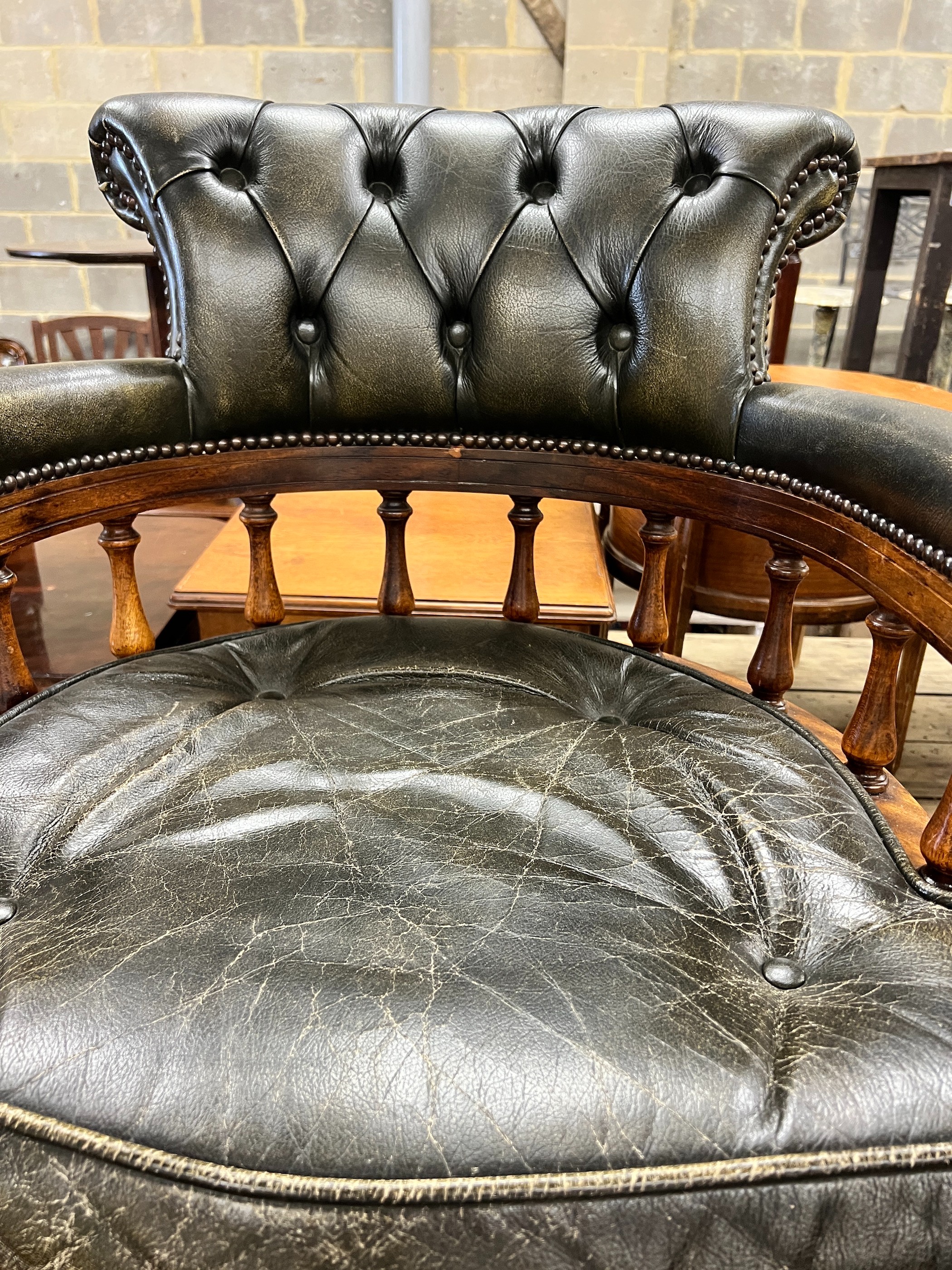 A Victorian style buttoned green leather mahogany swivel desk chair, width 62cm, depth 58cm, height 85cm